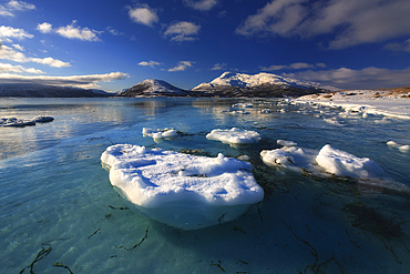A winter view looking out in Tjeldsundet strait towards the Saetertinden mountain in Troms County, Norway.
