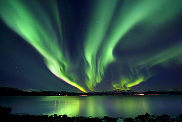 Aurora Borealis over Tjeldsundet in Troms County, Norway. Auroras are the result of the emissions of photons in the Earth's upper atmosphere.