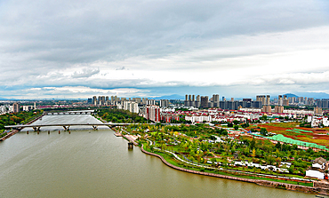 View of Jinhua City and Yiwu River on an overcast day. The tier 2 city with a population of 7.2 million has a history dating back to the 2nd century BC. Zhejiang Province, China.