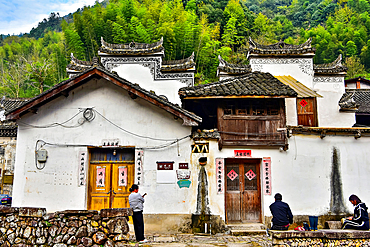 Villagers chilling outside a house in Shanxiabao village, Wuyi County, Jinhua City, Zhejiang Province, China. Under cultural protection, the 800 year old ancient village was featured in Chinese National Geography and still has buildings from 1723-1735.