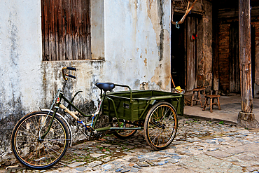 Tricycle outside an old house in Changle Village, Lanxi County, Jinhua City, Zhejiang Province, China. The village's history dates back to the Song Dynasty (960-1279) with it's oldest standing building being ~700 years old (late Yuan Dynasty).