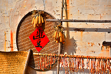 Pumpkin strips and corn being sun dried in autumn in Huangling, Wuyuan County, Shangrao City, Jiangxi Province, China. Huangling is an ancient village that dates back to the Ming Dynasty more than 500 years ago and is known for its natural beauty.