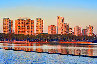 Cityscape of Jiujiang City at sunset over the Sai Lake, Jiangxi Province, China.