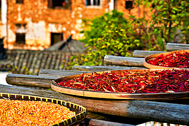 Chillies, corn and other produce being sun dried in autumn, Huangling, Wuyuan County, Shangrao City, Jiangxi Province, China. Huangling is an ancient village that dates back to the Ming Dynasty more than 500 years ago and is known for its natural beauty.