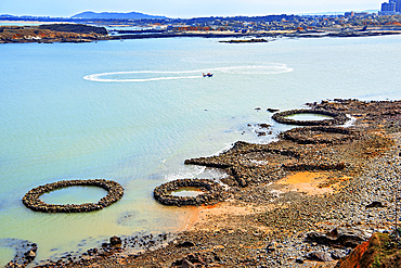 Circular and star shaped rock pools by the sea. Pingtan Island, Fuzhou City, Fujian Province, China.
