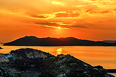 Golden sunset over the hills and the sea of Pingtan Island, Fuzhou City, Fujian Province, China.