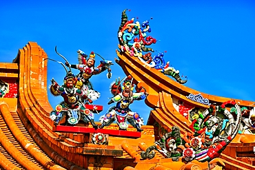 Intricate porcelain inlay sculptures on the rooftops of Chenghuangmiao (City God Temple) of Puning City, Guangdong Province, China. Porcelain inlay sculpture is a cultural heritage art form from the Chaozhou and Shantou area of Guangdong Province.