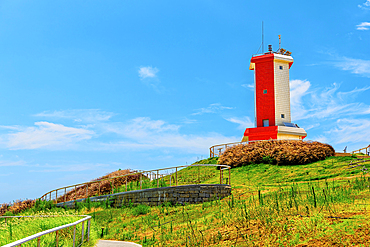 Red and white lighthouse at Little Weihai, a picturesque seaside fishing town in Shishi, Quanzhou, Fujian Province, China