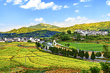 View of new buildings and farms beside Chengkan Ancient Village, Huangshan City, Anhui, China. Chengkan Ancient Village was established 1800 years ago by the Luo family clan. It has buildings dating as early as the Song Dynasty (960 to 1279 AD).