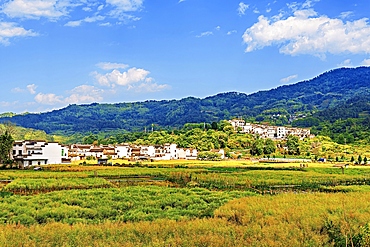 View of new buildings and farms beside Chengkan Ancient Village, Huangshan City, Anhui, China. Chengkan Ancient Village was established 1800 years ago by the Luo family clan. It has buildings dating as early as the Song Dynasty (960 to 1279 AD).