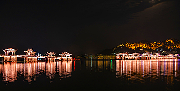 Guangji Bridge at night. Built in 1170, it is one of China's four famous ancient bridges. Chaozhou, Guangdong province, China. The bridge is connected by 18 boats that can be moved to allow passage for vessels. The bridge is disconnect at night.