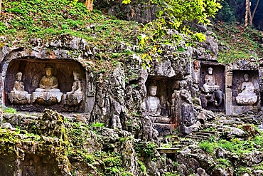 Ancient stone carvings and statues of arhats, Bodhisattvas and Buddhas on the hillside of Feilaifeng (Flying Peak), Lingyin Temple, Hangzhou, Zhejiang Province, China. These ancient statues and carvings date as far back as around 900A.D.