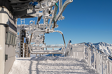 Empty chairlift station and benches at a shut down ski resort in the Poland mountains