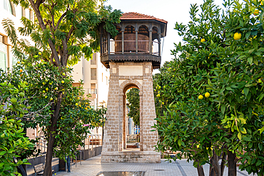 Old Historical Water tower with tangerine trees onthe foreground in Rishon Lezion, Israel. City landmark.