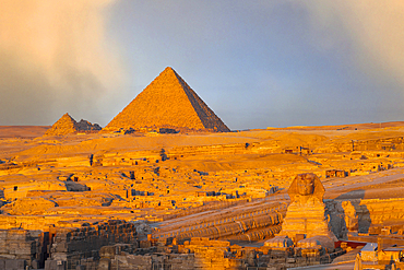 Clouds at dawn over The Sphinx and Giza pyramids, Cairo, Egypt