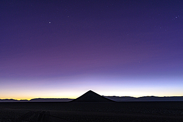 Silhouette of Cono de Arita at sunrise, Salar de Arizaro, Puna, Salta, Argentina