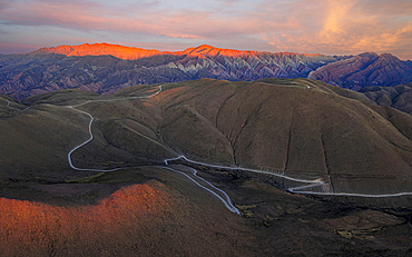 Winding road beneath sunset sky, Serrania de Hornocal, Humahuaca, Jujuy, Argentina