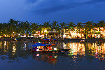 Tourist boats on the illuminated Thu Bon River at dusk, Hoi An, Quang Nam Province, Vietnam