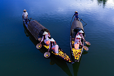 Women releasing floating lanterns into Nhu Y River, Hue, Central Vietnam. (MR)