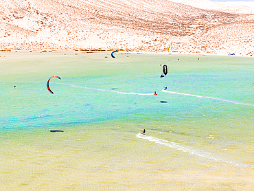 Aerial view of kitesurfers surrounded by volcanic cliffs, Sotavento beach, Jandia, Fuerteventura, Canary Islands, Spain