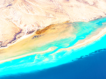 Overhead view of volcanic cliffs overlooking the crystal sea, Sotavento beach, Jandia, Fuerteventura, Canary Islands, Spain