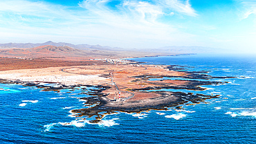 Aerial view of El Toston Lighthouse on volcanic coastline, El Cotillo, Fuerteventura, Canary Islands, Spain