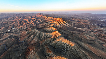 Aerial view of desert mountains and volcanic landscape at sunset from Sicasumbre viewpoint, Fuerteventura, Canary Islands, Spain