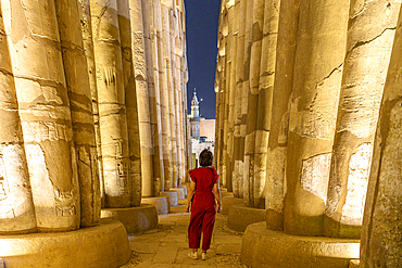 Tourist exploring Luxor Temple's colonnade, Luxor, Nile Valley, Upper Egypt