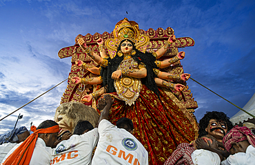 Municipal workers push a clay idol of Goddess Durga to immerse into the Brahmaputra River on the concluding day of the Durga Puja festival, in Guwahati, Assam, India on 2 October 2025.