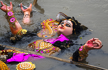 Hindu devotees immerse a clay idol of Goddess Durga into the Brahmaputra River on the concluding day of the Durga Puja festival, in Guwahati, Assam, India on 2 October 2025.