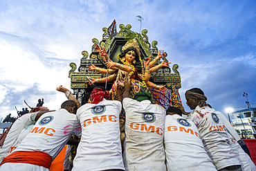 Municipal workers push a clay idol of Goddess Durga to immerse into the Brahmaputra River on the concluding day of the Durga Puja festival, in Guwahati, Assam, India on 2 October 2025.