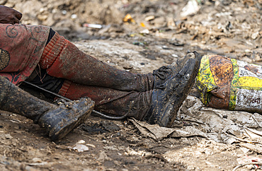 Dirty shoes of a ragpicker after collect reusable items at a garbage dumping site on May 27, 2025 in Guwahati, India.