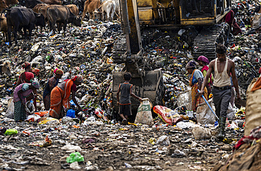Ragpickers collect reusable items at a garbage dumping site on May 27, 2025 in Guwahati, India.