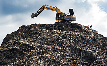 Municipality excavator working at a garbage dumping site on May 27, 2025 in Guwahati, India.