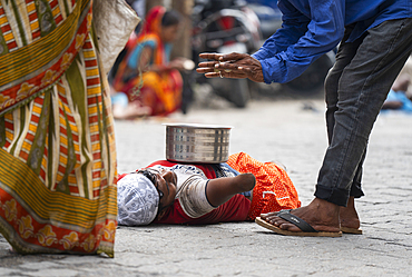 A beggar with disability begs outside an Eidgah during Eid al-Adha in Guwahati, India on 7 June 2025.