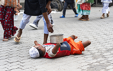 A beggar with disability begs outside an Eidgah during Eid al-Adha in Guwahati, India on 7 June 2025.