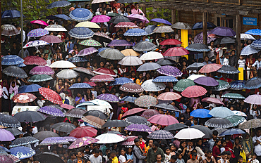 People attend an event holding umbrellas to mark the Behdienkhlam festival in Jowai, India, on July 14, 2025.