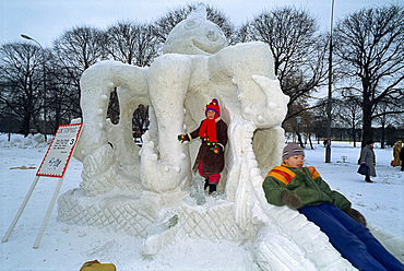 Children play on an octopus ice sculpture during the Ice Sculpture Festival in Gorky Park in Moscow, Russia, Europe