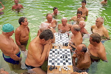 Bathers playing chess in the water at the Szechenyi Baths in Budapest, Hungary, Europe