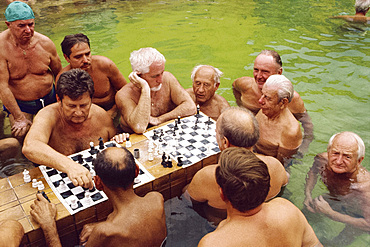 Bathers playing chess in the water at the Szechenyi Baths in Budapest, Hungary, Europe