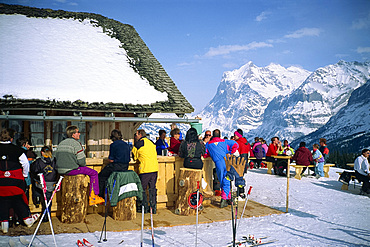 People take a break from skiing in mountain top bar, Wengen, Bernese Oberland, Switzerland, Europe