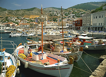 Fishing boats in the harbour, with the town behind and hills in the background on Hydra, Argo Saronic Islands, Greek Islands, Greece, Europe