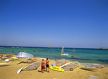 Couple going windsurfing at Golden Beach on Paros, Cyclades, Greek Islands, Greece, Europe