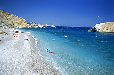 Couple in sea on the edge of Katergo Beach, on Folegandros, Cyclades Islands, Greek Islands, Greece, Europe