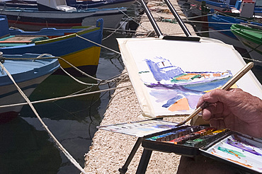 Close-up of artist painting boats in a harbour, Italy, Mediterranean, Europe