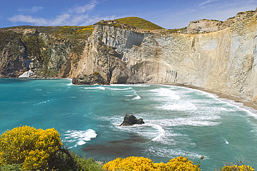 Chalk cliffs surrounding a small emerald coloured bay on the island of Ponza, off the southwest coast of Italy, Italy, Mediterrranean, Europe