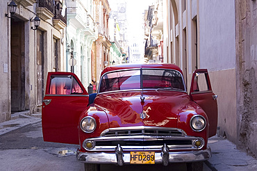 An old car in a small street in Habana Vieja (old town), Havana, Cuba, West Indies, Central America