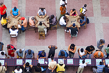 People playing chess and dominoes at a school festival in Parque Cespedes, Santiago de Cuba, Cuba, West Indies, Central America