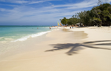 The shadow of a palm tree on the beach and emerald sea Guardalavaca Beach, Guardalavaca, Cuba, West Indies, Central America