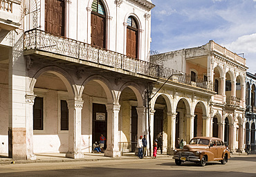 A vintage American car coming along Avenida Reina in central Havana, Cuba, West Indies, Central America